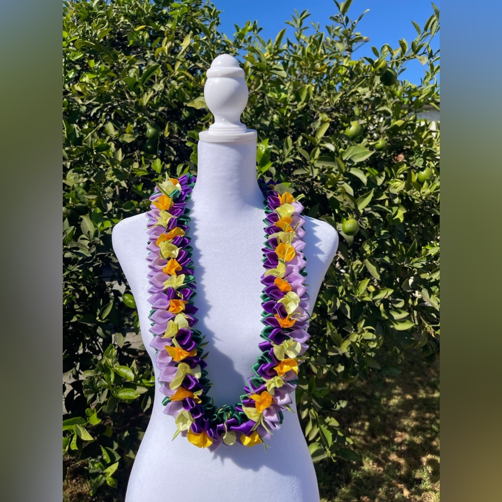All handmade leis with ribbons. Purple and yellow Pansy flat. 41 inch
